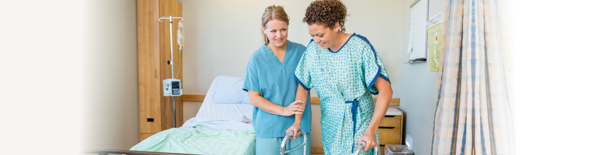 nurse assisting woman in walking